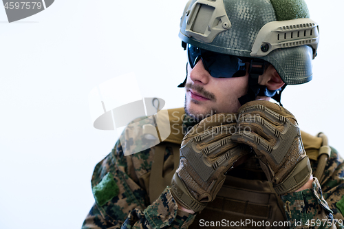 Image of soldier preparing gear for action