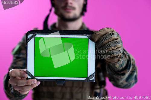 Image of soldier showing a tablet with a blank green screen