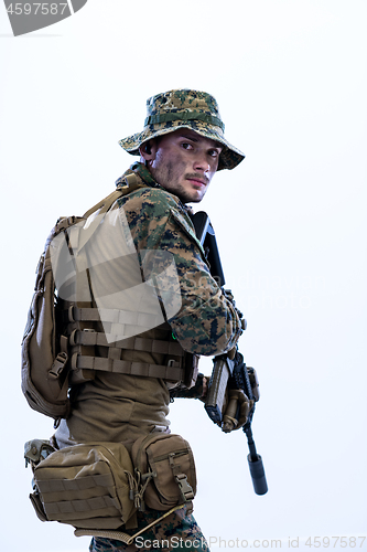 Image of soldier in action aiming laseer sight optics