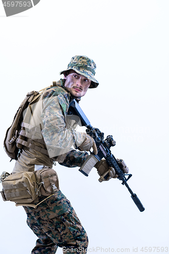 Image of soldier in action aiming laseer sight optics