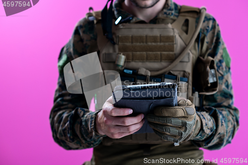 Image of soldier using tablet computer closeup