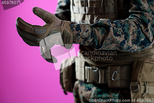 Image of closeup of soldier hands putting protective battle gloves pink b