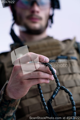 Image of soldier praying tespih