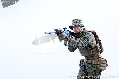 Image of soldier in action aiming laseer sight optics