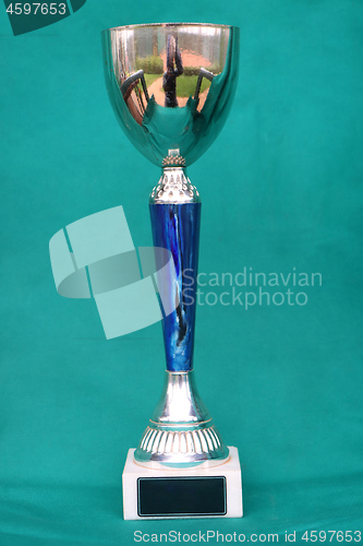 Image of Champion cup with reflection on green background