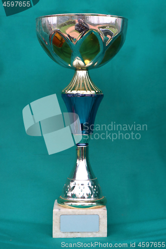 Image of Champion cup with reflection on green background