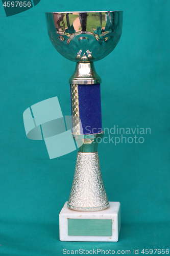 Image of Champion cup with reflection on green background