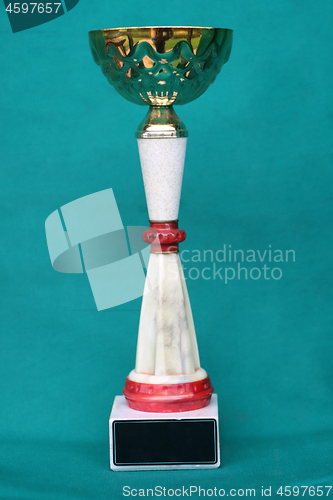 Image of Champion cup with reflection on green background