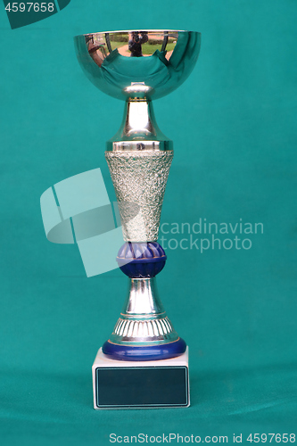 Image of Champion cup with reflection on green background