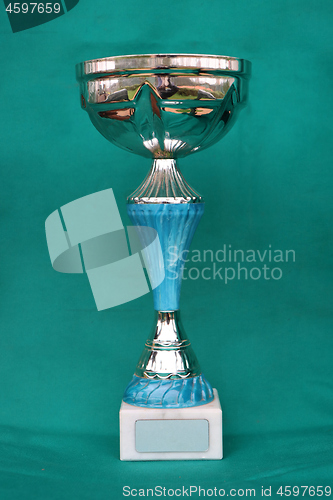 Image of Champion cup with reflection on green background