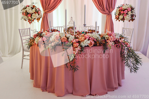 Image of Beautifully decorated wedding table with flowers and candles