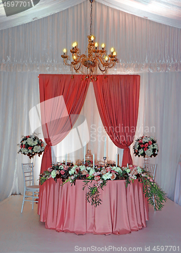 Image of Beautifully decorated wedding table with flowers and candles