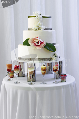 Image of Big wedding cake with three storey decorated by white and pink r