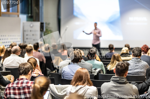 Image of Business speaker giving a talk at business conference event.