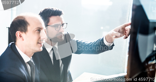 Image of Business team analyzing data at business meeting in modern corporate office.