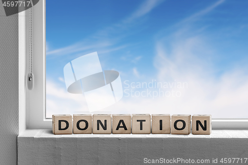 Image of Donation sign standing in a window