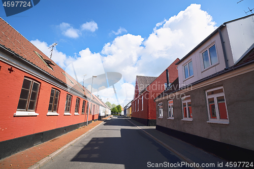 Image of Empty street with red buildings