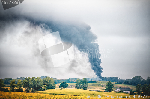 Image of Black smoke from a fire in a rural countryside