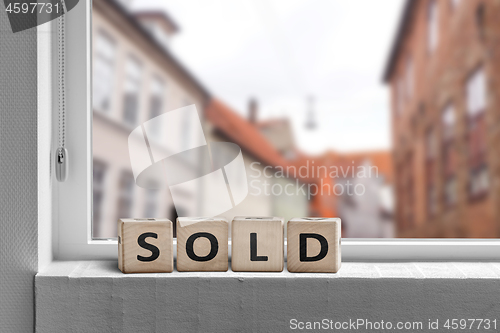 Image of Sold word made with cubes in a window