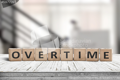 Image of Overtime word spelled with wooden blocks