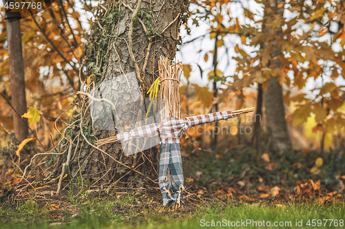 Image of Rural scarecrow standing in a garden