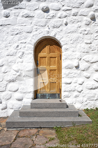 Image of Wooden door with a stairway on an old building