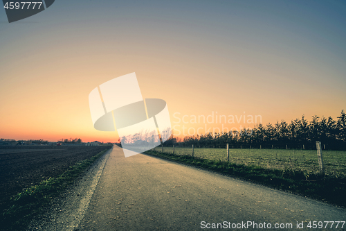 Image of Road to a sunset in a rural environment