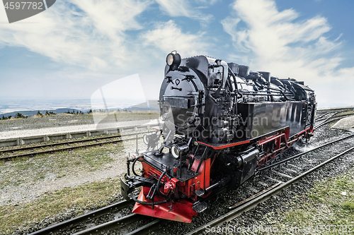 Image of Locomotive on railroad tracks at a station