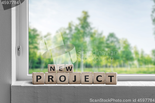Image of New project sign in a window sill