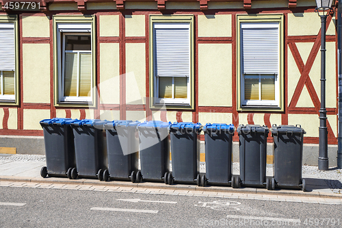 Image of Garbage bins on the street outside an old house