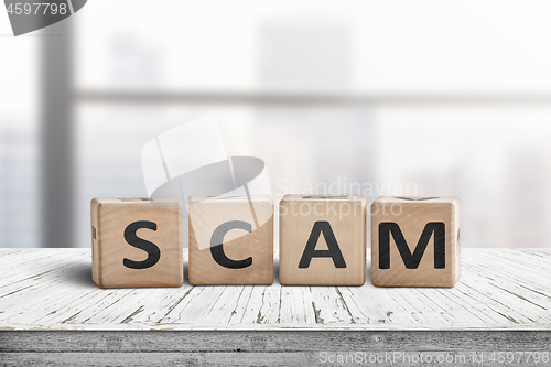 Image of The word scam made of wooden blocks