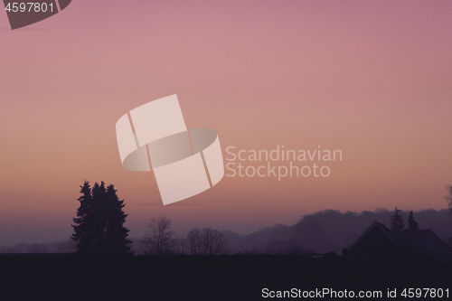 Image of Violet morning sunrise over rooftops