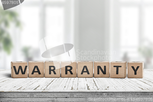 Image of Warranty sign on a wooden desk