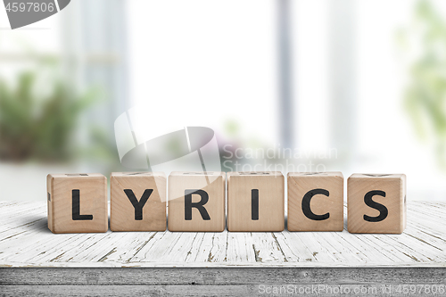 Image of Lyrics sign on a table in a bright room