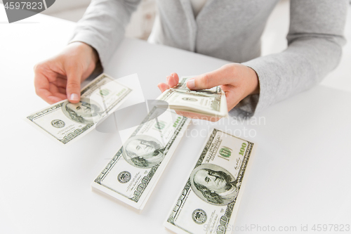 Image of close up of woman hands counting us dollar money