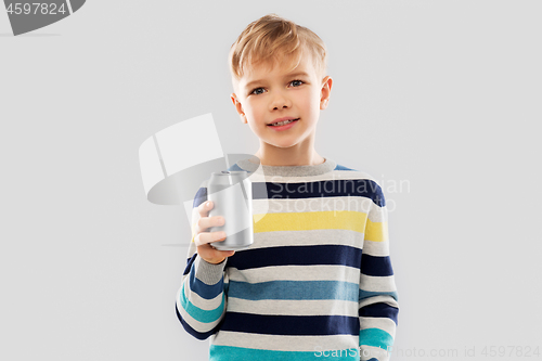 Image of portrait of little boy with soda can drink