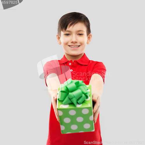 Image of smiling boy in red t-shirt with birthday gift box