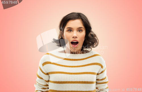 Image of surprised young woman in striped pullover