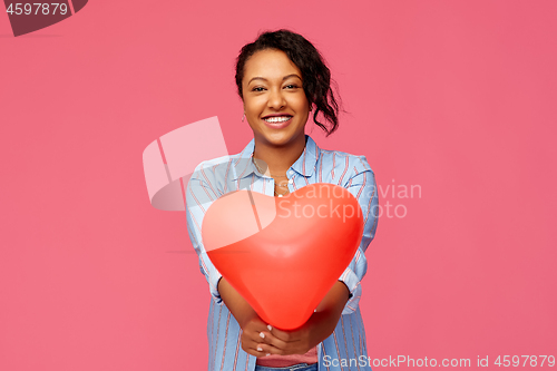 Image of african american woman with heart-shaped balloon