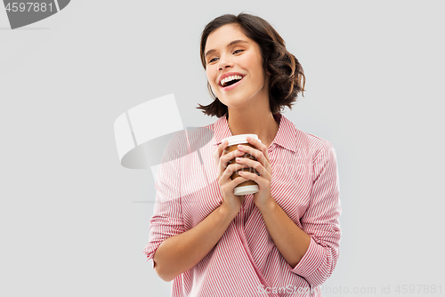 Image of woman drinking takeaway coffee in paper cup