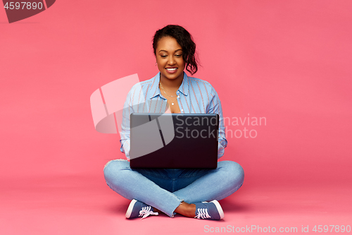 Image of happy african american woman with laptop computer