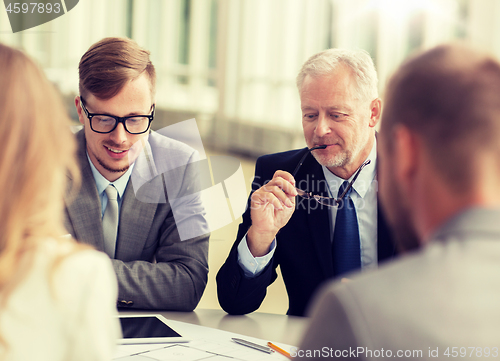 Image of architects with tablet pc and blueprint at office