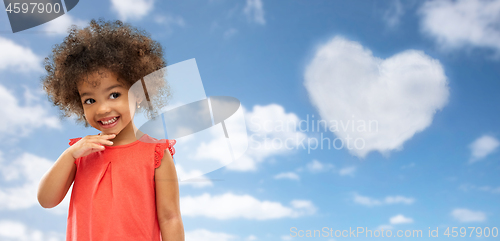 Image of happy little african american girl over blue sky