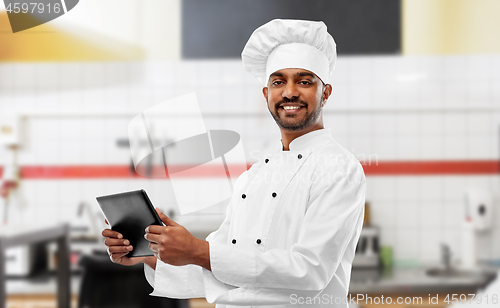 Image of indian chef with tablet pc at restaurant kitchen