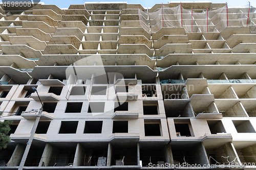 Image of High-rise construction of a new building, decoration of the facades of the first floors