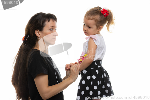 Image of Mother looks at her daughter with discontent