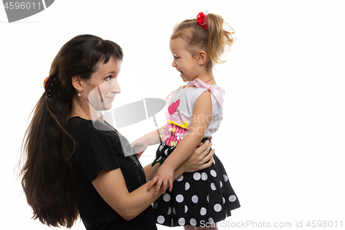 Image of Mom and four-year-old daughter look at each other with fun