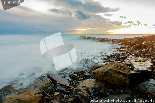 Image of shroud of raging sea on a rocky shore