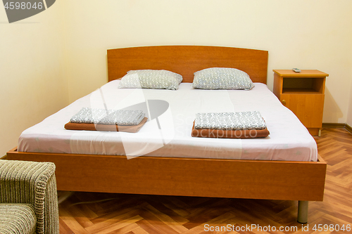 Image of A double bed in the interior of the guest house