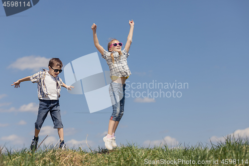 Image of Brother and sister playing on the field